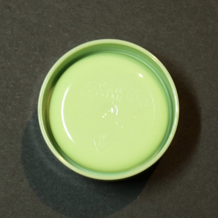 bottom view of a green makeup remover