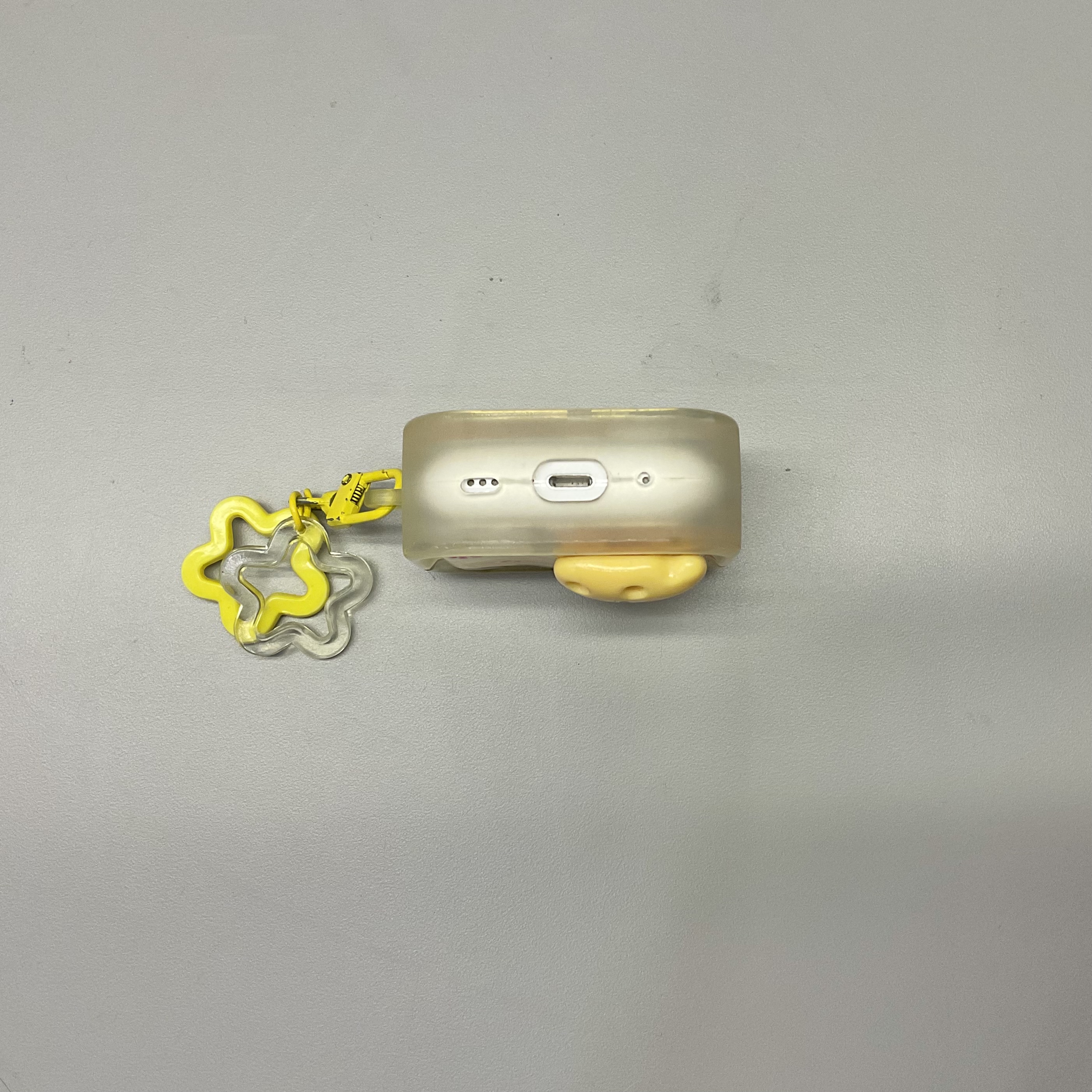 bottom view of a yellow earbuds case