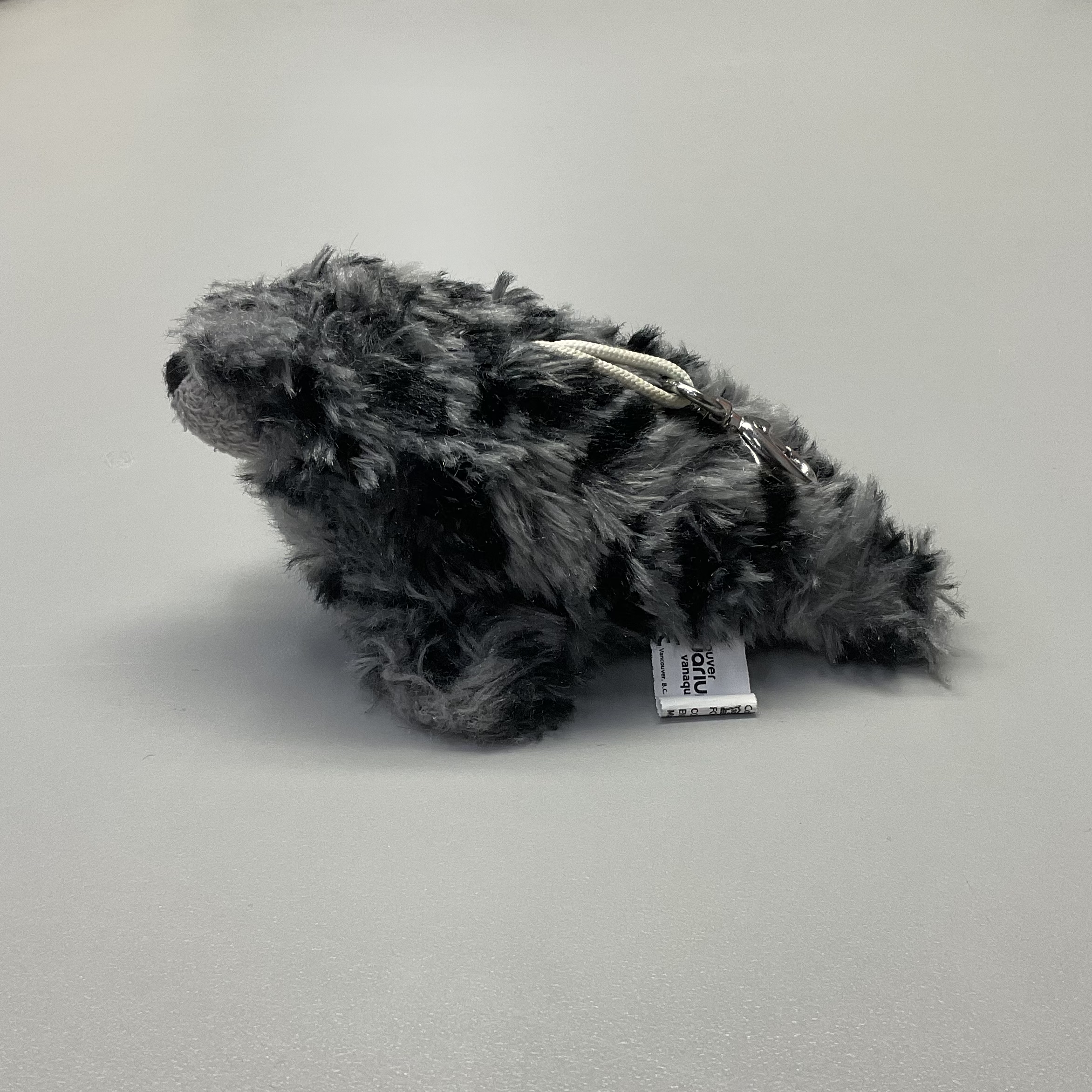 side view of a grey seaotter plush doll